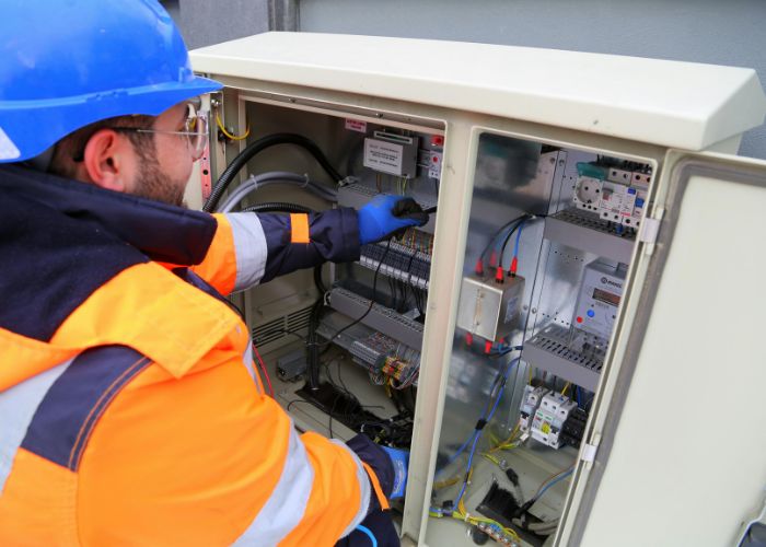 Commercial electrician inspecting electrical wires
